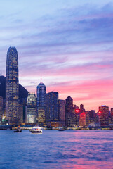 Hong Kong city skyline at sunset with glowing sky and skyscrapers