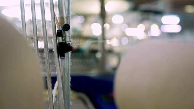Close up of sensor and machine connection in a modern textile production line. Professional industrial footage reflecting automation, technical control and manufacturing technology.