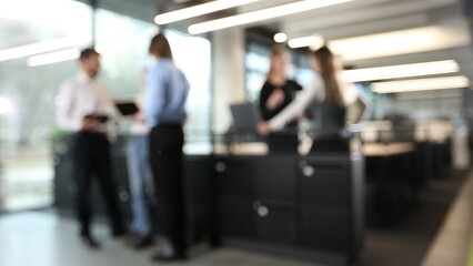 Naklejka premium A group of people are standing in a room, some of them are holding laptops