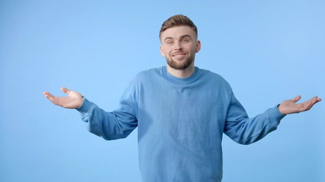 Confused young man shrugging shoulders with uncertainty