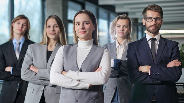 A group of people in suits and ties are posing for a photo