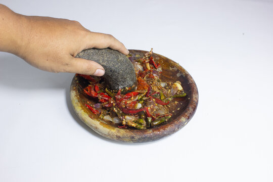 Close-up of sambal ulek served with fried tempeh and salted fish, highlighting bold flavors, rich texture, and authentic Indonesian traditional food pairing.