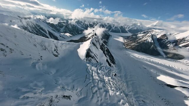 The Dikiy Pass, icefall, and Zvezdochka Glacier at sunset. Mountains of Kyrgyzstan. Tien Shan. 4K