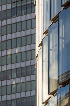 Glass facade office building in modern corporate district with urban architecture lines showing windows reflection on contemporary exterior and city business mood