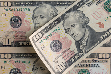 Close-up of 10 US Dollar Bills with Alexander Hamilton Portrait and We the People Inscription