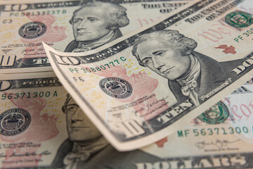 Close-up of 10 US Dollar Bills with Alexander Hamilton Portrait and We the People Inscription
