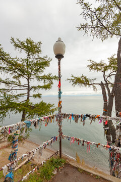 Sacred Ritual Ribbons Hadak on Lake Baikal Shore in Listvyanka with Copy Space for Travel Concept