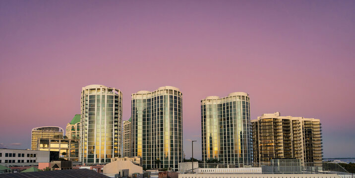 Modern Luxury Residential Skyline at Sunset with Pink and Purple Sky