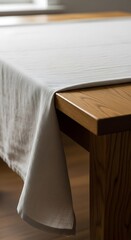 Elegant Linen Tablecloth on Wooden Table Corner.