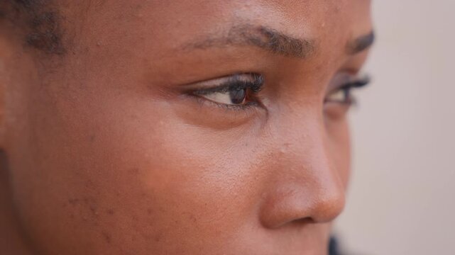 closeup black woman pensive gaze, soft warm light, visible skin texture and freckles, subtle tear forming, student reflecting on exam results, actor rehearsing monologue, mother holding private