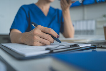 Senior Female Doctor Thinking While Working on Laptop