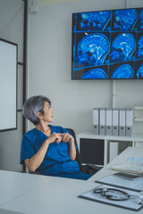 Female Doctor Observing Brain Scan Results in Clinic