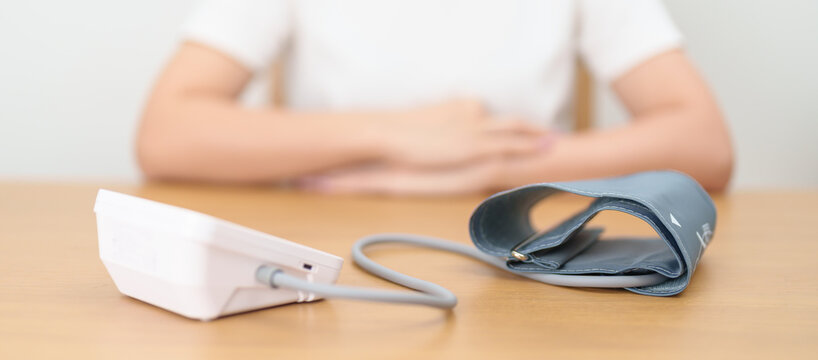 woman checking Blood pressure by Blood pressure monitor with Cuff. Systolic, SYS, Diastolic, DIA, Pulse, Hypertension, Hypotension, Heart rate, Cardiovascular Disease and May World hypertension day