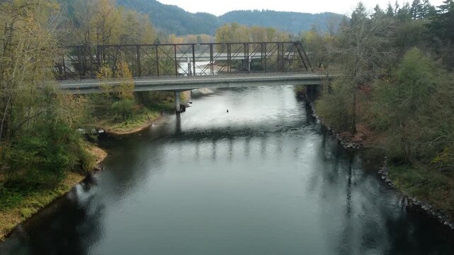 US, OR, Eugene, , 2025-11-23 - Drone view of the Coburg Bridge, old railroad bridge that is now a walking path, and I-5 beyond over the McKenzie River in fall