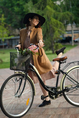 Fototapeta premium Happy young woman with a bicycle