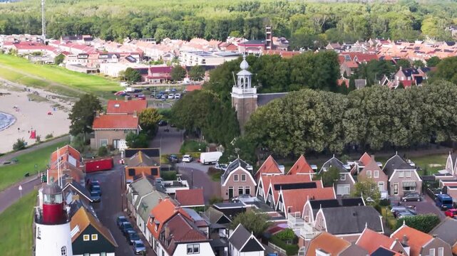 Aerial winter footage of Urk fishing village harbor and lighthouse