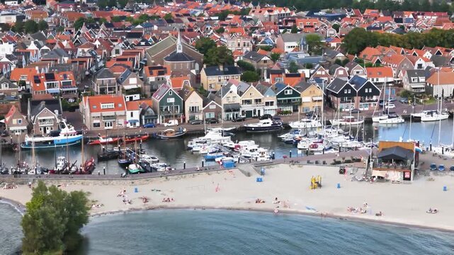 Aerial winter footage of Urk fishing village harbor and lighthouse