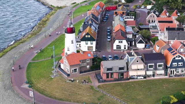 Aerial winter footage of Urk fishing village harbor and lighthouse