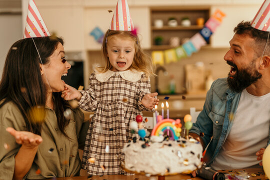 Young child watching confetti falling celebrating special occasion