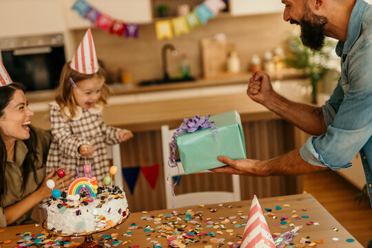 Father presenting gift to happy smiling daughter