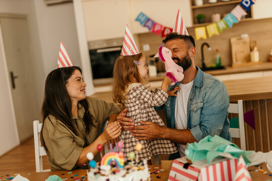 Family bonding with child playing cheerfully at home