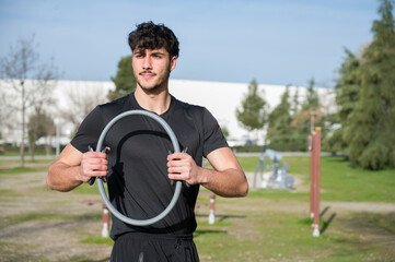 Fototapeta premium Fit Young Adult Practicing Strength Training with Pilates Hoop