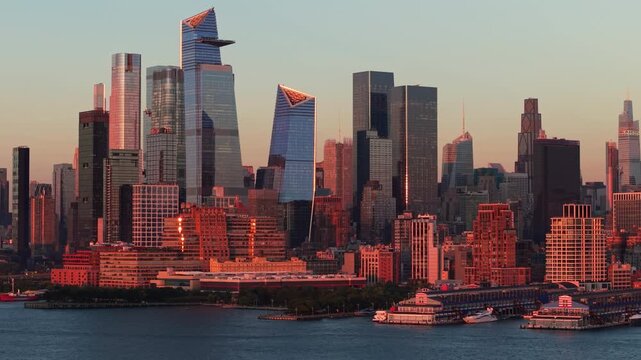 New York City skyline with Midtown West and Hudson Yards skyscrapers at sunset. Aerial view of Chelsea and Hudson River Park piers