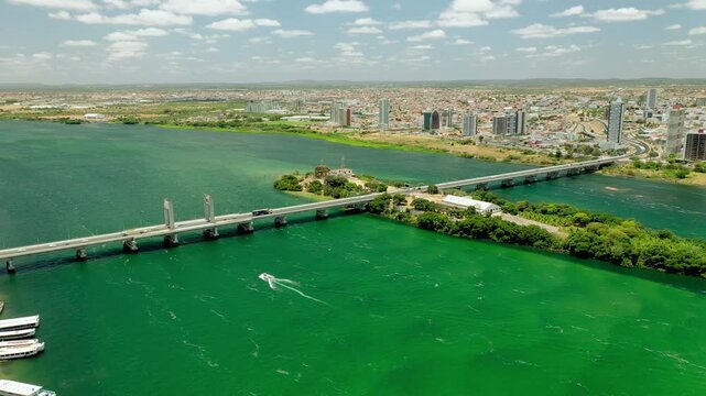 Aerial daylight view 28 March 2025 of S&atilde;o Francisco River Bridge spanning the river, showing flowing water, connected infrastructure, and scenic northeastern Brazilian landscape.