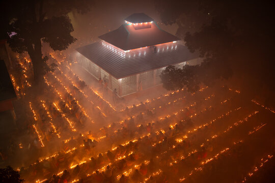 Aerial view of a mosque illuminated by rows of candles, casting a golden glow across the landscape, Narayanganj, Dhaka Division, Bangladesh.