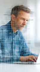 Man using laptop computer man focused on screen typing on a laptop technology work online activity