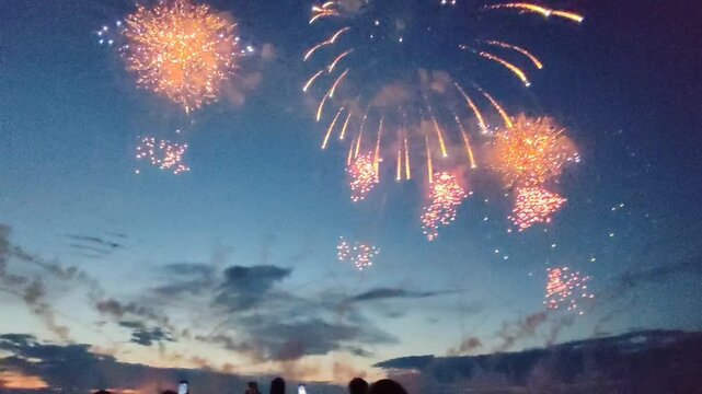 Colorful fireworks exploding in the night sky during  celebration, bright sparkling lights, dramatic bursts and glowing trails, festive atmosphere.