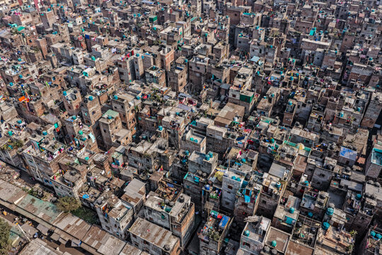 Aerial view of densely packed buildings with blue water tanks form a textured tapestry of urban living, Dhaka, Dhaka Division, Bangladesh.