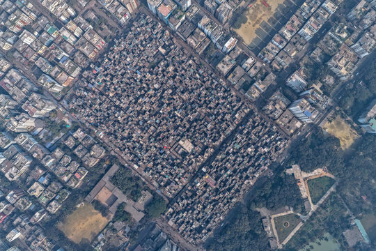 Aerial view of a densely populated area with closely packed buildings casting shadows, creating a textured urban landscape, Dhaka, Dhaka Division, Bangladesh.