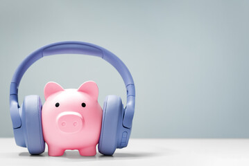 Piggy bank wearing headphones, finance podcast concept