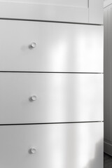 Minimal white dresser in modern interior with soft light