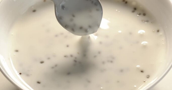 Yogurt with chia is mixed with a spoon and taken.
