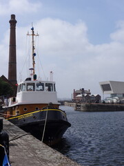 Docked tugboat moored at industrial harbor waterfront © Svchka