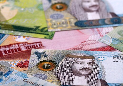 Bahraini dinar money bills pile on table. Bahrain banknotes of BHD currency close up.