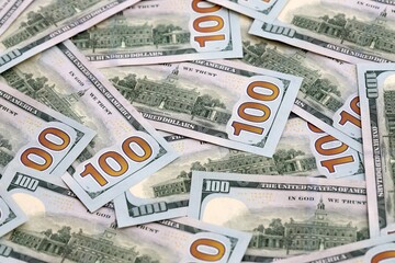 Obraz premium US dollar money bills pile on table. United States banknotes of USD currency close up.