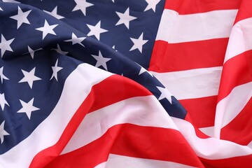 Official flag of United States of America with folds and waves close up. Patriotic background