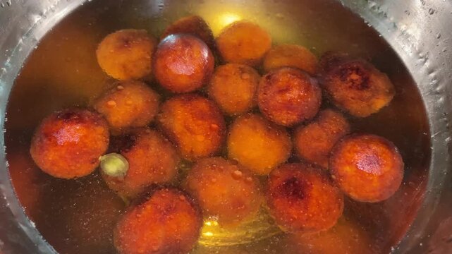 fried gulab jamun in sugar syrup