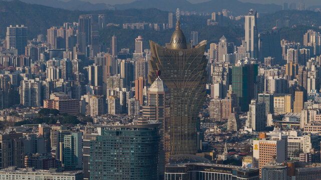 Cotai, Macao - 18 February 2026: Aerial view of a dense cityscape dominated by the iconic Grand Lisboa Hotel, its golden facade shimmering amidst a sea of buildings.
