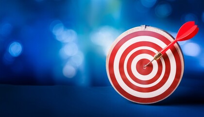 Fototapeta premium a red arrow hit the center of the target on a blue blurred background representing business goals and a concept of success