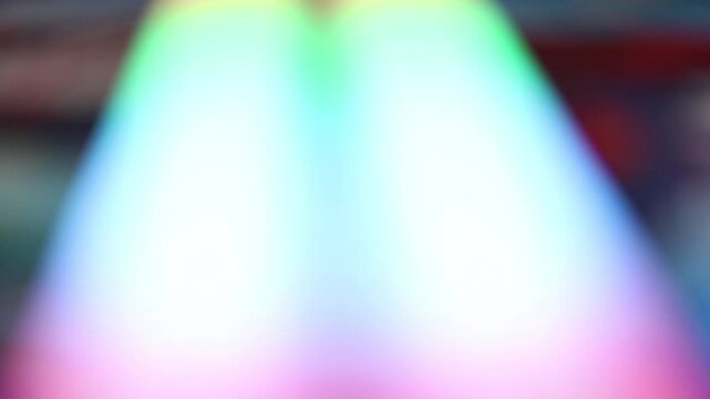 Abstract neon bokeh background with flowing colorful lights in soft focus.