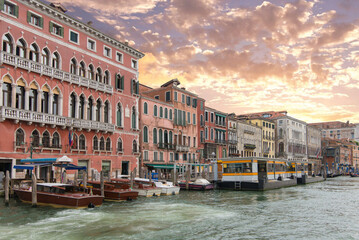 Historic palazzos and wooden water taxis on the Grand Canal at sunset © Sergey