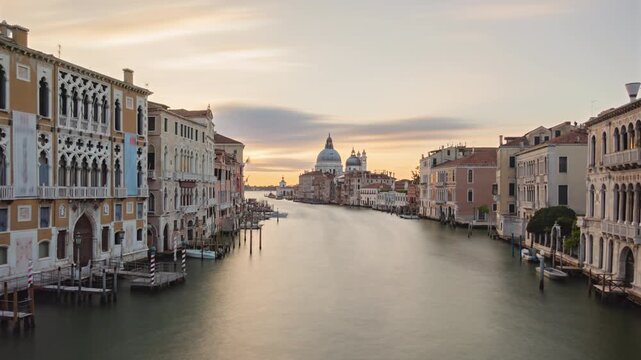 Night to day transition very long exposure time lapse Grand Canal traffic and Basilica di Santa Maria della Salute, view from Accademia bridge, Venice, Italy