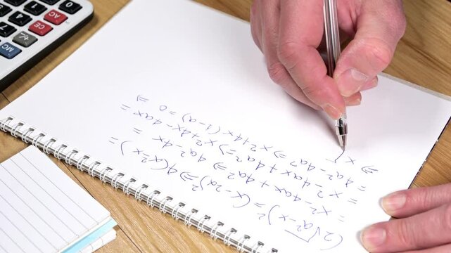 student is solving a difficult equation on blank paper