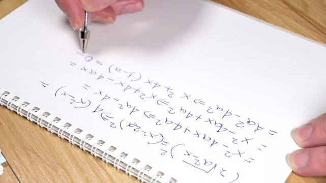 student is solving a difficult equation on blank paper