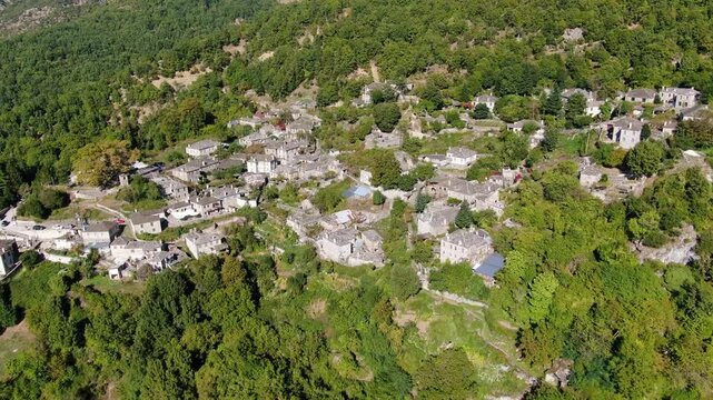 Aerial drone view of traditional stone village Papingo in Zagori Epirus Greece, historic architecture with slate roofs in green mountains.