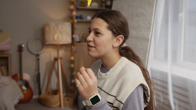 Handheld shot of smiling tutor showing right pronunciation while student trying to repeat it
